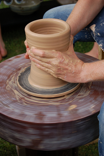 A closeup of a pottery vase in the process of being made